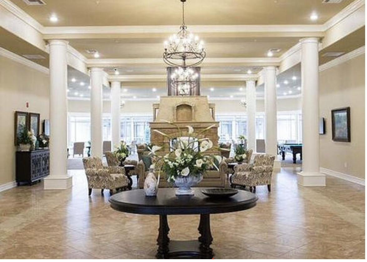 Grand institutional commercial lobby with columns and chandelier